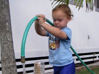 imgp1866  Sam loves to water plants (any excuse to play with the water) and learned how to hold the hose like a Fireman. He's taking care of our transplanted palm trees here.