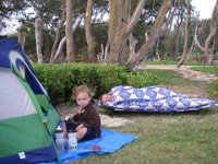 IMGP2235  The next morning. Mom had planned on sleeping under the stars, the way she grew up camping (on just a tarp). She tried our cot for the first time - it got good reviews. She also bought a shower curtain to hide under in the event of sprinkles, which did indeed come during the night. We had a tarp she could have used but she wanted a more feminine look - ha ha! Sammy is being a good boy playing while I make breakfast.