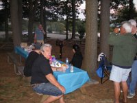 IMGP4950  Dave grilled up enough burgers and dogs to feed 24 people. We had a great time! I think he's on the phone with Bill here, trying to help him find the park. Bill realized he had directions in his wallet after making about 5 phone calls to us - we were juggling greasy hands and starving boy while trying to vector him in :) "Just head for the lake!"