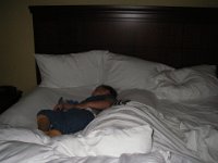IMGP5382  Sleeping in mommy's bed in Phoenix before flying out on Hawaiian Airlines. I rolled up some towels as barriers to keep him from flopping over onto my side :)