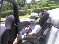 ATT00007  Sam got to ride over to Auntie Angel's in her convertible! Here he's doing the rock-on sign for you :)