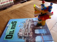 P6270002  "Freeschool" lesson for the week. I'm enjoying learning about jack-up and semi-submersible rigs, derricks, etc. Who knew they could drill down 3000' under the water! Wow. That's my Lego oil rig, too.
