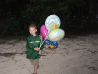 P1250059  He did this last year with a big Thomas balloon. Just LOVED taking it for a walk. This year he had FOUR balloons :)