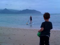 photo3  And coming home a bit wet :) I went in once. I tried to be very conservative because the break was right over a reef - like just inches below. You do not want that 12 ft board to land on your head and bash it into a reef. I really got the feel of it but need much more practice.