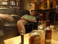 P5270001  Our friend Alan came through Hawaii enroute to riding a submarine back home to WA. Here we are tasting some Scotch and hanging out. He looks asleep, but he's not. He's plotting what to write in our guest book.
