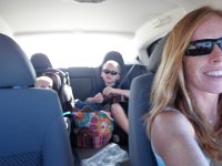 P6010133  The ride home - listening to Eddie Kamae, singing "yee-haw, we went to Haleakal-AH!", and passing snacks around. (I bite off the tail of a goldfish, hand it back to Sam, who is then instructed to hand it to Ben). You can see I'm being very good about ensuring they have enough water up there in the altitude, too.