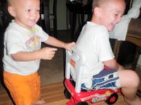 P8030001  This really cracked the boys up - Sam put his feet way up so Ben could push him around the house!