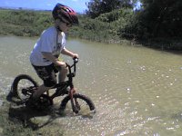 Photo0000 0308  Out on a mountain bike ride around base. Some deep puddles and slick mud!
