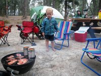 IMGP1894  We got a little sprinkled on and cold in the wind, so we went to the bathrooms and ended up taking a hot shower, after which dinner seemed in order. He we are grilling spam (yum on the grill!) and spaghetti and meatballs in a can. This is ultralight camping at its best. See the boys' faces? Pretty funny looks they're giving their dinner :)