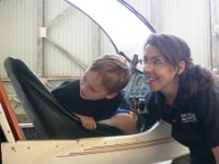 IMGP1588  April explaining how the elevator and flaps work on a glider. You can really get a feel for takeoff and landing, as well as steering, by using the controls and watching them move the elevator and flaps.