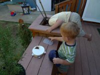 L1010931  Ok - so here's where it gets interesting. The lizard egg went down into the planter. Sam is rescuing it.