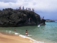 IMGP2066  Then on to Waimea Bay. Figured conditions were perfect for a jump, and there's no better time than with a couple youngsters visiting. My cousin Mike and his wife Mary were game for the parking lot waiting game, then when we bagged a spot I figured it was a sign that were gonna do it. Here I am taking the plunge! I was super nervous as I am not too keen on falling from heights, but the actual event was not nearly as big a deal as it felt at the time, high on the rocks. You wait for a swell to come in then jump right behind it to get max water depth.