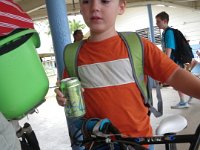 IMGP0385  The post where we meet Sam - so his bike is not tripping kids up while they stream into cars for pickup. I bring him a can of cold sparkling water for after school. Here Ben and I are on our bike to get Sam.