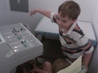 IMAG0263  Sammy is running the Xray machine - ruling out a stress fracture or any bone involvement from infection. Probably not necessary, but hey, good to be sure. Both boys crammed behind protective wall of control room.