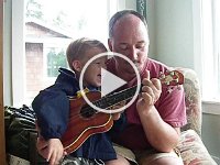 IMGP4182  Ben playing uke with Daddy's help doing chords. He really liked that.