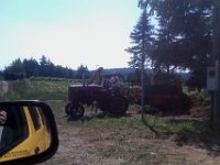 IMAG0762  The tractor at the farm stand! This is Karen. She let Ben sit up in the tractor and even turned it on for him! Now she is off to spread manure on the crops. What a neat place, just 1/4 mi from us.