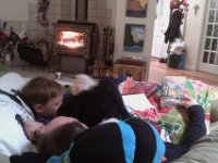 IMAG1154  Snuggling with Daddy in front of the fire.