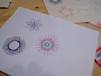 IMGP5823  The spirograph mom and Richard found for Christmas is such a great present. This one dates to 1967. They managed to find an original. I love it! There are drawings from a kid 40 years ago (or maybe only 3 yrs but I prefer to think the original drawings were made long ago and that child is now perhaps a parent). Sam and my drawings are in the foreground, the vintage ones on the original paper in the background. Here again, Sam gets very upset with imperfection. It presented another teaching moment - that we are all imperfect, and yet God loves us, and we love each other despite our flaws. The flaws actually remind me of the difficulty in striving for perfection - how pretty is a perfect creation really? A bit boring I think. When you see a pen go off course once it reminds you of the care that had to be taken to create every flawless orbit.