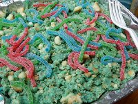 IMGP6542  This is "scratch" - the leftover cake crumbles from cutting Ben's cake into a cube, plus some gummi worms. I had the zany idea to eat it like chickens. And so we did - using beaks to get the worms. Some of our "roosters" tried to give the worms to their hens, but the hens were not so interested. Tijen and I might possibly have tried to eat from the same plate with our beaks, too. The men thankfully missed most of this silliness.