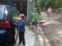 IMAG1758  Getting ready to go to war - testing all the equipment for Friday's water gun war! There's Gramma, too!