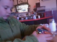 IMAG2202  Cubing at the restaurant! The 7x7! Looks like he's doing it with eyes closed :)