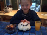 Pic-10042013-001  The Harvest Fair creation! Sam is home sick from school so Ben is holding up our family's end of the Harvest Fair entry with a patty pan squash from the garden.