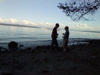 Pic-09212013-007  Comparing notes, with Seattle in the background. We're at a tiny beach at a road end.
