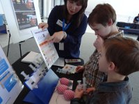 Seattle PSC 001  The Pacific Science Center does a visiting Scientist Spotlight every now and then. It is fantastic - the kids get to see real scientists talk about their work with engaging, hands-on displays. It is WHY I renewed our membership today. This woman works on a vaccine for leishmaniasis, a parasite that can be deadly. : Seattle PSC