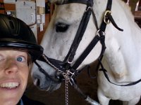 20140616 113950  Emmy and I after a lesson. Emmy was a little nutty this day maybe because of the rain. She spooked three times on the way up the driveway! We ended up having a great lesson. I decided not to lunge her first - that lunging was really more about me than her (i.e., getting her ya-yas out in advance of hopping on gives me a psychological boost but may not be necessary now that I have more experience).