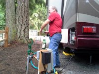 20140617 165858  Richard hooking up the RV - he is trying to open up a hose. I like the face!