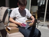 20140619 135845  Sam unpacking his first phone! We got him a no-contract GoPhone like I have. Not a smart phone, but has camera and can talk/text as needed for $2/day.