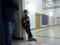 20150110 102240  Proud big brother wearing his ice hockey jersey, looking on at the game. Sam has a game right after this. But first I have to go to Wal-Mart and buy a birthday present and take Ben to a party. I had everything precisely timed.