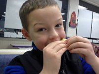 20150115 170828  Starting to feel a little better after Tamiflu. Eating a crunchwrap slider at Taco Bell - that was his sick boy dinner wish :)