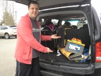 20150212 160121  Clever hockey dad runs sticks up through some kind of big cardboard tube so he can get them in and out of the SUV without digging and breaking them.