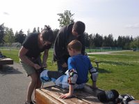 20150430 162136  Such a great community -two parents pitching in to get Ben's skates tightened.