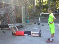 20150626 173024  Calisthenics time! We do odd workouts once a week. Sam went into the garage to find something to bench press and came out with a ladder.
