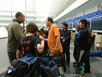 DSC 0324  So they don't use locker rooms - the club just gears up on the side of the rink. This is the upper grades (4,5,6). Sam and his friend Tyler (also from Bremerton ice hockey) are meeting the club director (orange shirt) and head coach Issei.